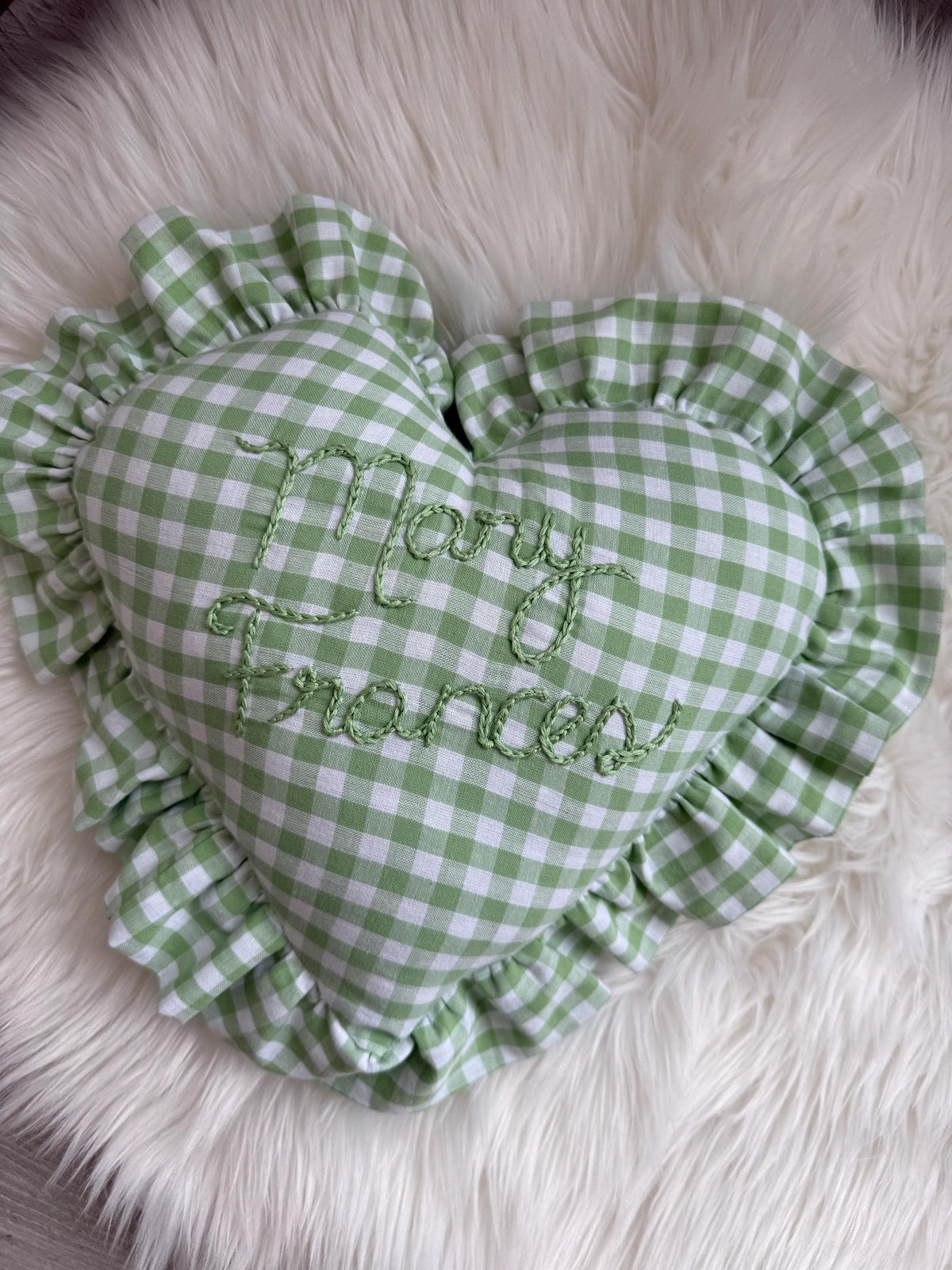 Green and white gingham heart throw pillow with embroidered name and ruffled edge