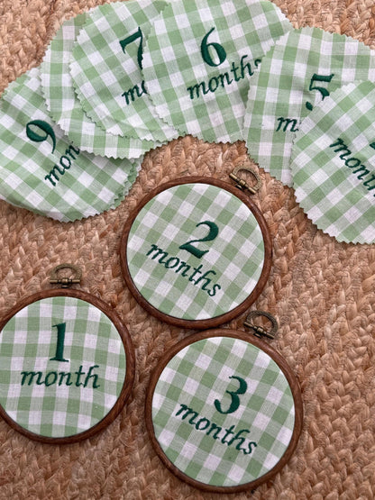 Green gingham milestone hoop set with hoops for months 1–6 in wooden rings