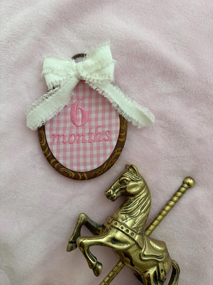 Pink gingham '6 months' milestone disc with mint bow and gold rocking horse